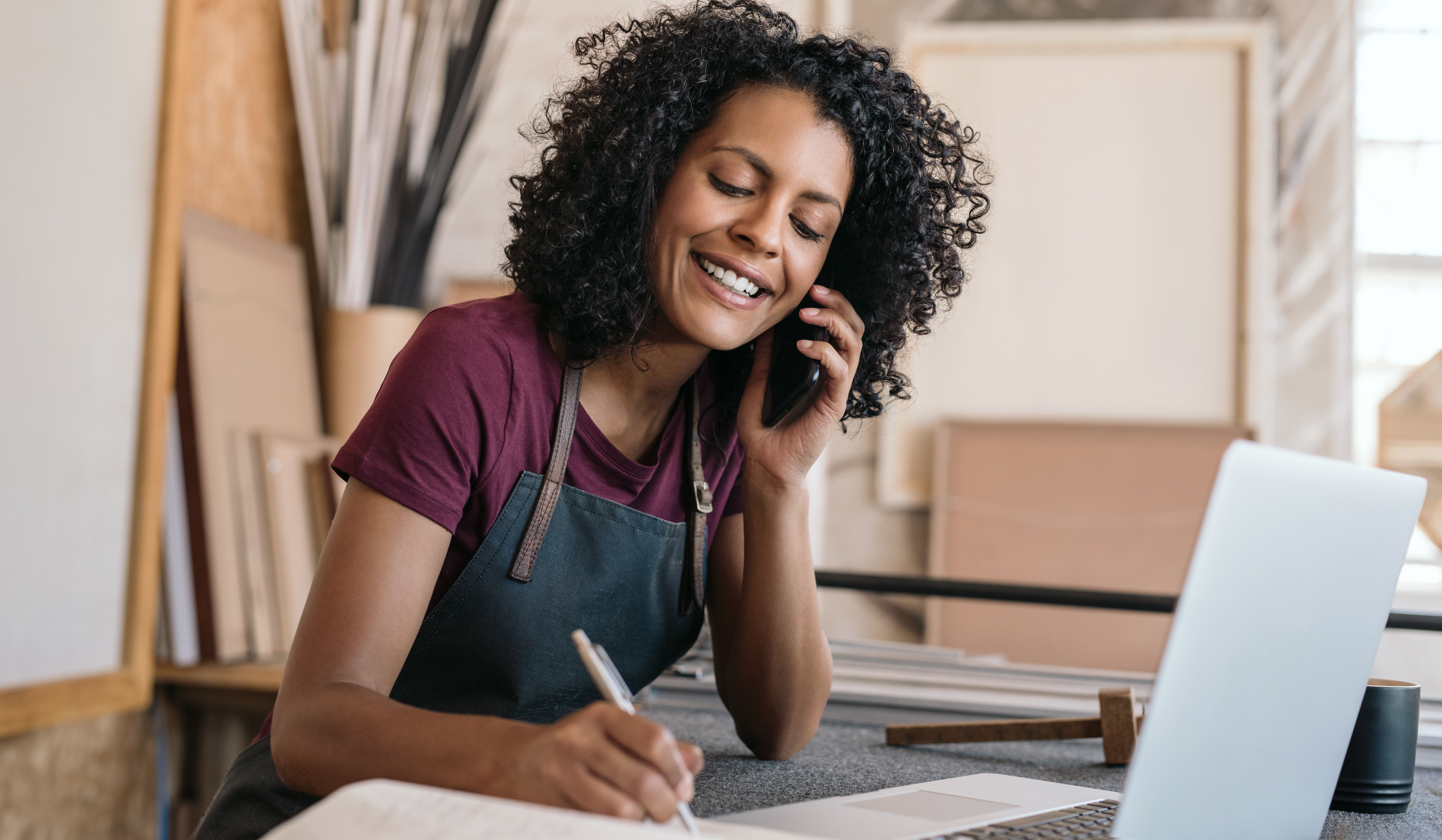 Small business owner smiling on a call with a customer